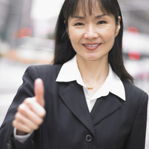 Businesswoman giving thumbs up